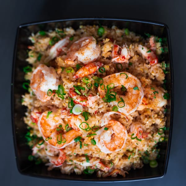 Seafood fried rice with shrimp and crawfish, topped with green onions.