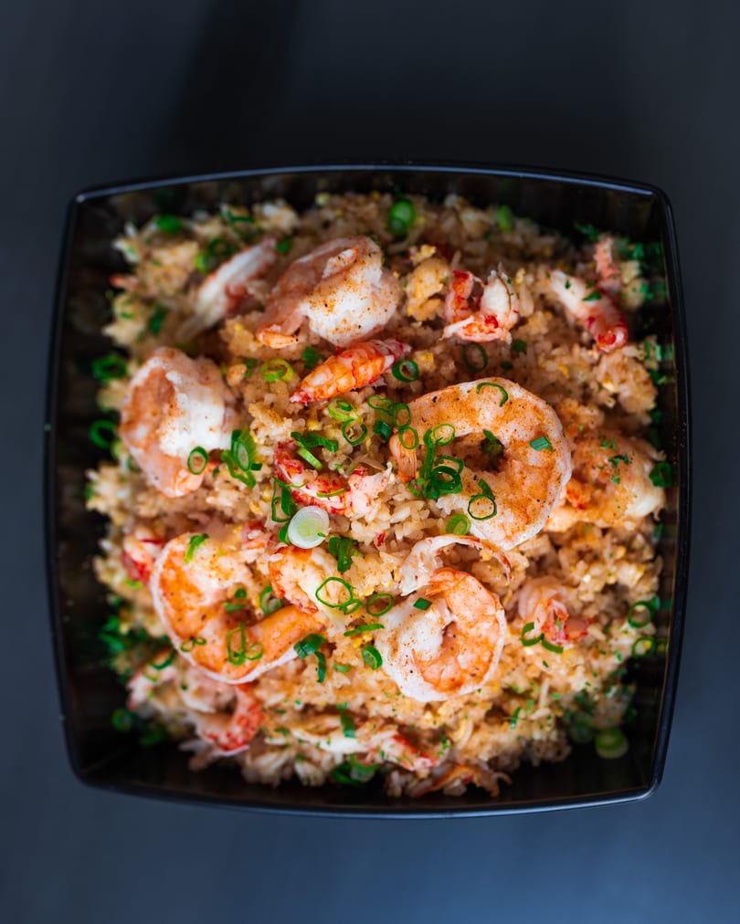 Seafood fried rice with shrimp and crawfish, topped with green onions.